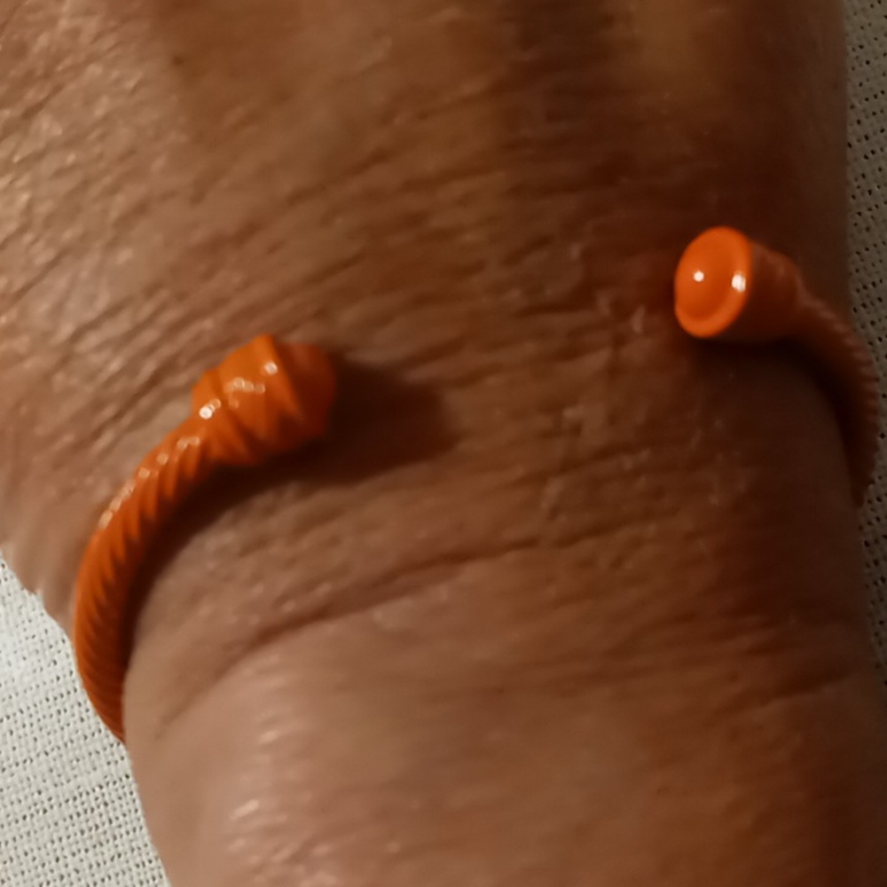 Orange twisted cable cuff bangle bracelet.